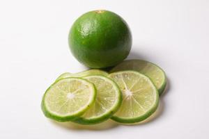 Sliced lemon with leaves on a white background photo