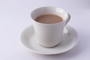 Coffee in a white mug on a white background. Copy space. photo