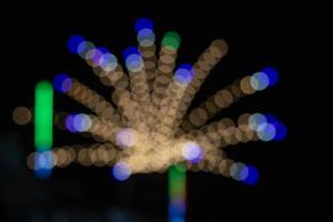 Blurred light with bokeh background of temple fair in Thailand.Abstract blurred circular bokeh background. photo