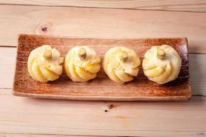 Phulae pineapple on a plate on a wooden background photo