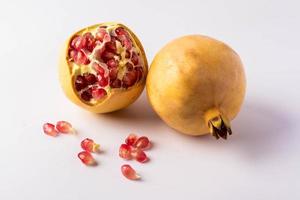 Yellow pomegranate on a white background photo