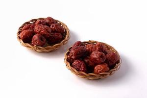 Dried jujube in a plate on a white background photo