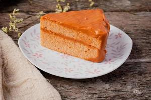 Triangle Thai tea cake on wooden background photo