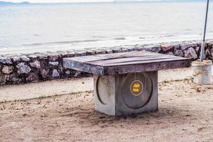 Empty wooden table by the sea photo