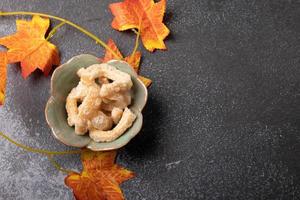 pork rind in a cup on a black background. Thai food photo