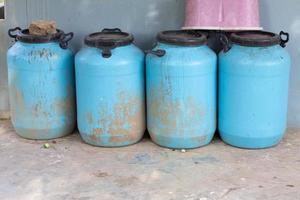 4 blue plastic buckets lined up photo