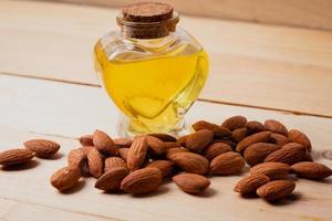 Almond oil on a wooden background photo