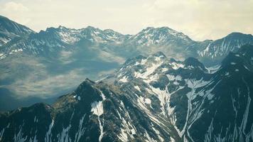 Aerial Over Valley With Snow Capped Mountains In Distance video