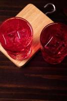 Red flavored nectar drink on a wooden background photo