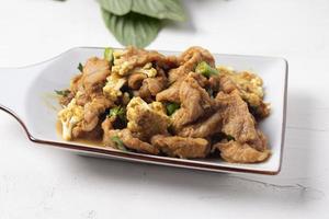 Stir Fried Pork with Green Curry Paste in a White Background photo