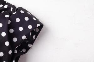 Polka dot black napkin on a wooden kitchen table View from above with copy space photo