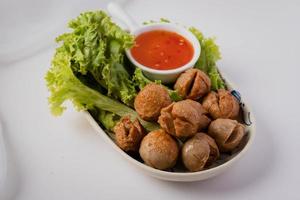 Fried meatballs and dipping sauce on a white background photo