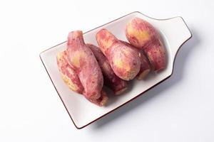 Small boiled yam, placed in a plate on a white background photo