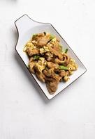 Stir Fried Pork with Green Curry Paste in a White Background photo