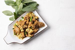 Stir Fried Pork with Green Curry Paste in a White Background photo