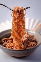 Spoon and Fork Scooping Instant Noodles photo
