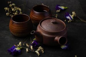 Antique brown chinese tea set on black background photo