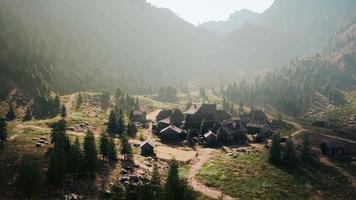 Old wooden village on the rocky mountain background video