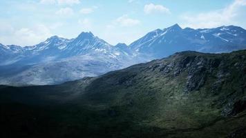 Aerial Over Valley With Snow Capped Mountains In Distance video