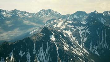 Aerial Over Valley With Snow Capped Mountains In Distance video