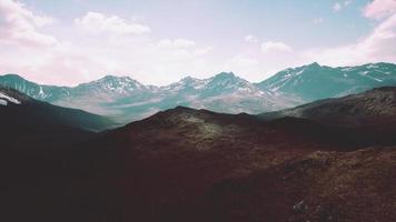 Aerial Over Valley With Snow Capped Mountains In Distance video