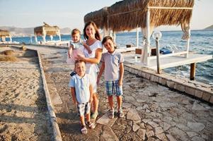 Mother with three kids on Turkey resort against Mediterranean sea. photo