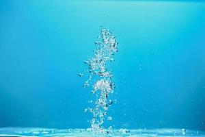 Abstract background image of bubbles in water. Clean water with water droplets and waves. Fresh water a glass with bubbles blue background. photo