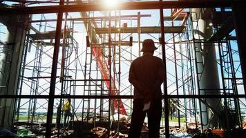 Worker man standing at the construction site photo