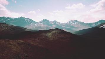 Aerial Over Valley With Snow Capped Mountains In Distance video