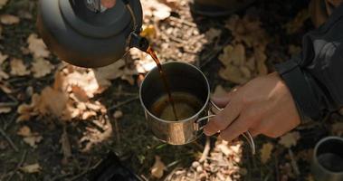 Close up of solid fuel stove with water kettle on fire, tea or coffee prepearing outdoors video