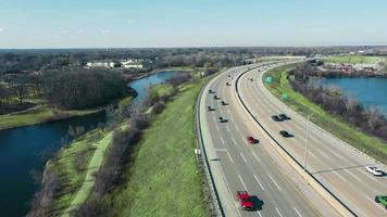 Flight over the highway and car traffic moving in the direction of the big city. Large highway with heavy traffic. video