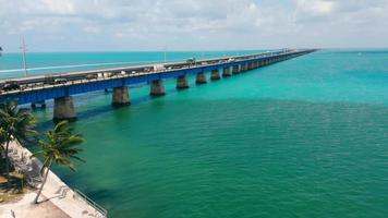 Old bridge running over ocean surface, next to operating one in Florida Keys, USA. Aerial drone view of Old Bahia bridge along ocean with horizontal oceanscape, copy space. Concept of architecture video