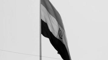 India flag flying at Connaught Place with pride in blue sky, India flag fluttering, Indian Flag on Independence Day and Republic Day of India, waving Indian flag, Flying India flags - Black and White video