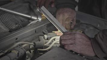 Mechanic Tightening the Screws of the Faulty Car Engine with a Star Wrench. video