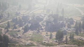 Old wooden village on the rocky mountain background video