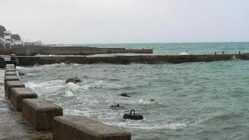 Waves crushing against breakwater. video