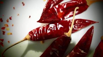 Red Chili Peppers, Chili Pepper Flakes shown against a white background photo