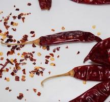 Red Chili Peppers, Chili Pepper Flakes shown against a white background photo
