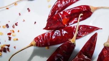 Red Chili Peppers, Chili Pepper Flakes shown against a white background photo
