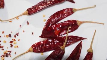 Red Chili Peppers, Chili Pepper Flakes shown against a white background photo