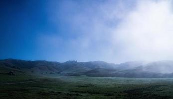 Blue sky rolling hills California early morning fog photo