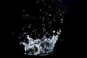 Scattered water splashes on a black background. water splash isolated on the black background photo