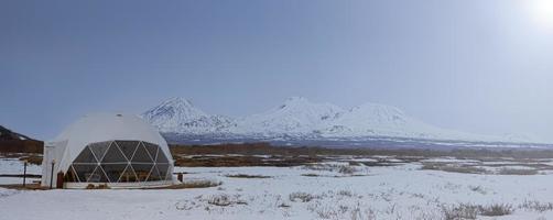 Glamping house and volcano, rural landscape, tent houses in Kamchatka peninsula. Selective focus. photo