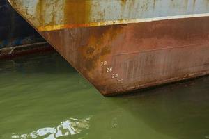 nose fishing trawler with figures on the water photo