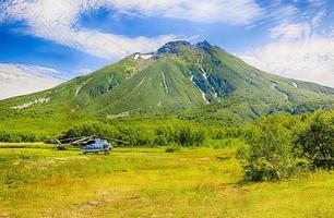 Volcano and helicopter in Kamchatka photo