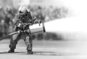 Firefighters while extinguishing the fire with a special fire extinguishing equipment. photo
