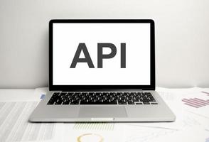 concepto api con portátiles y gráficos en papel. desarrollo de software foto