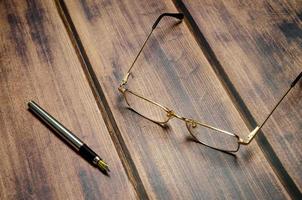 Blank notebook with pen are on top of white office desk table. Top view with copy space, flat lay. photo