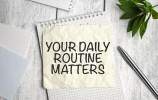 Handwriting text writing Your Daily Routine Matters on notebook photo