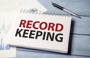 Word text RECORD KEEPING on white paper card business concept photo